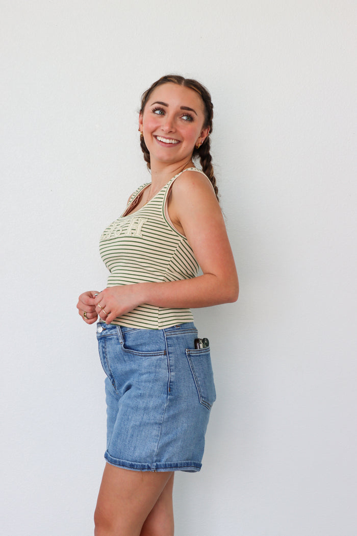 girl wearing green striped "beach" tank top