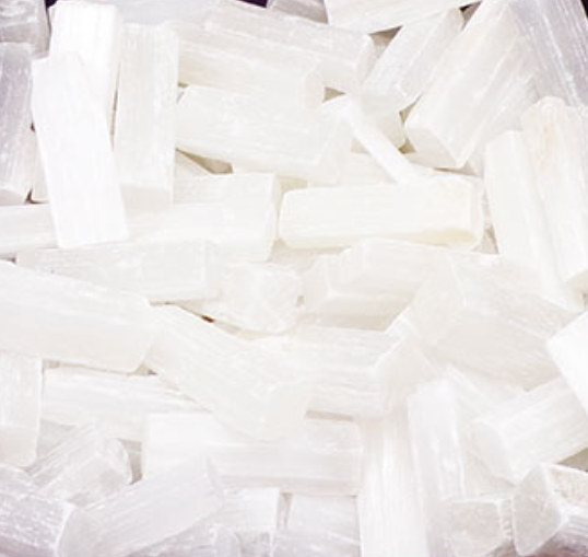 Box of selenite sticks with a purple and gold box labeled 'Selenite'.