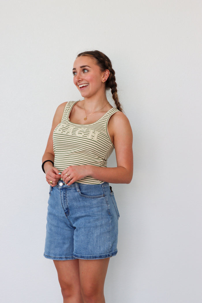 girl wearing green striped "beach" tank top