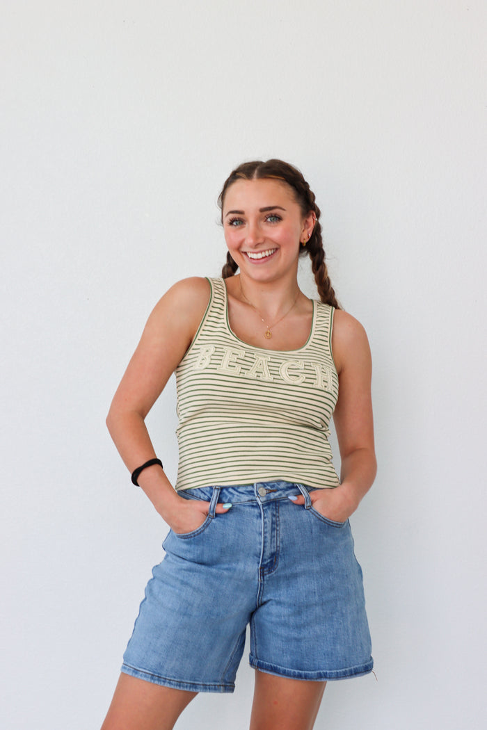 girl wearing green striped "beach" tank top