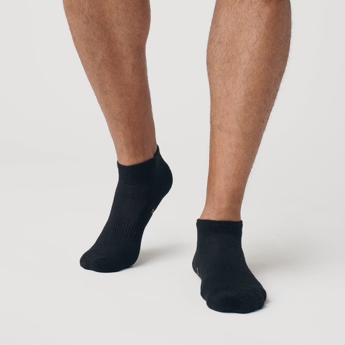 Black Ankle Socks 12-Pack on feet, showcasing seamless toe design.