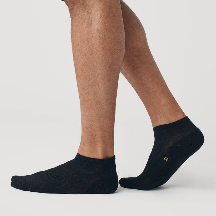 Black Ankle Socks 12-Pack worn on feet, showcasing seamless toe design.