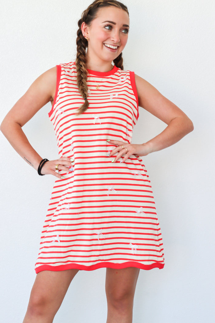 girl wearing red striped dress with bow detailing