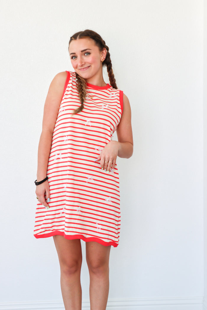 girl wearing red striped dress with bow detailing