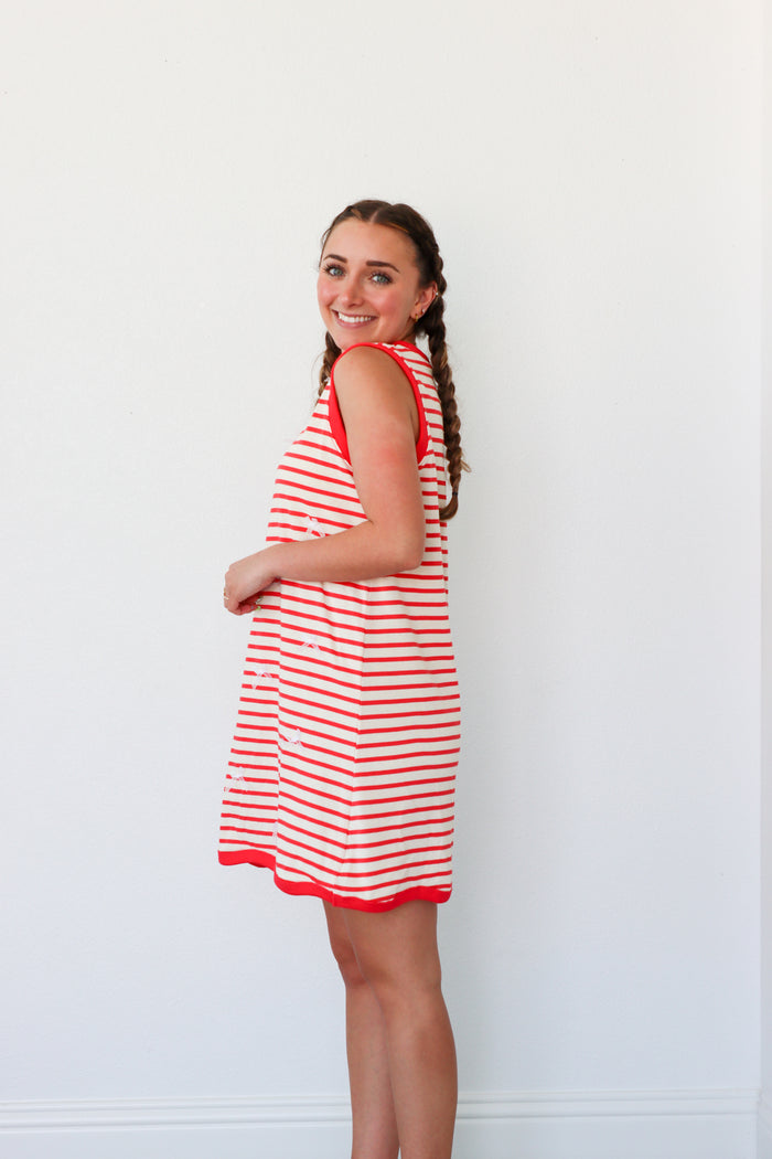 girl wearing red striped dress with bow detailing