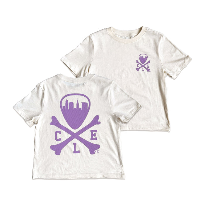 Two off-white short-sleeve t-shirts shown on a white background, one displaying the back with a large purple crossbones, shield, and 'CLE' graphic, and the other showing the front with a small matching purple chest graphic.