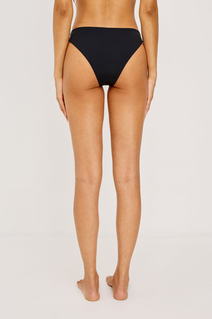 Corsica Bikini Bottom With Fixed Side Straps and Cheeky Rear Coverage in Black Colorway - Lower Body Back View Featured on Model