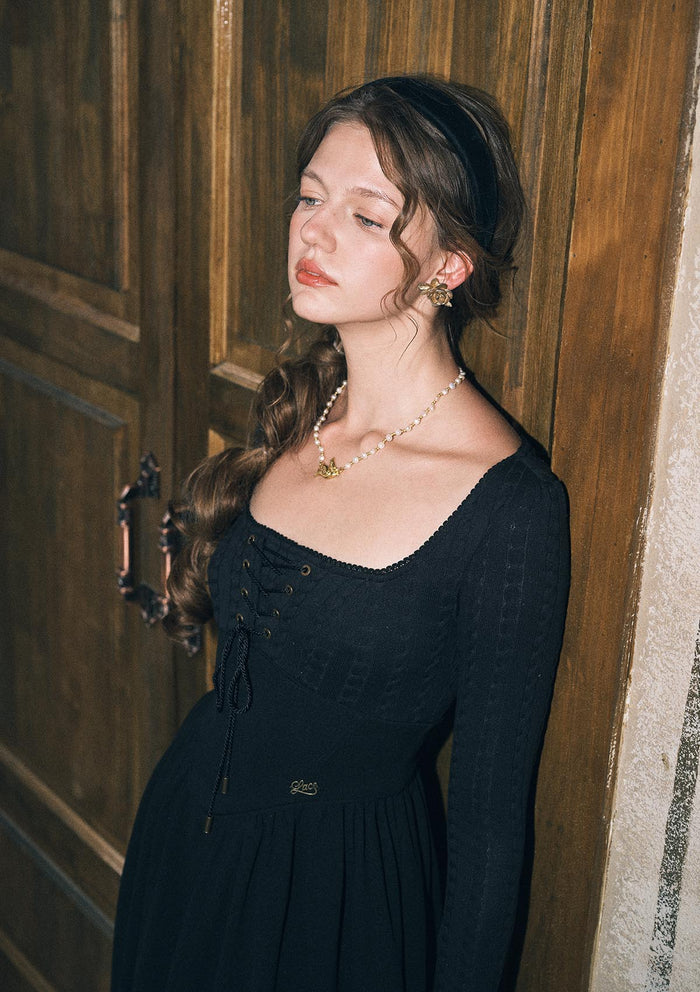 Close-up of adjustable tie neckline on Courtyard Rendezvous black knit dress