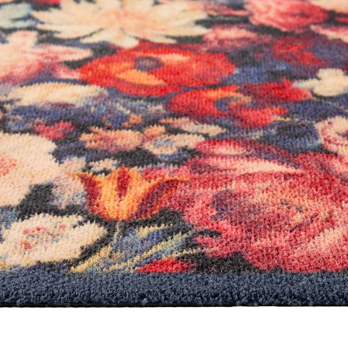 Dark Florals Washable Runner- a 100% recycled cotton runner featuring oversized floral blooms in shades of red, cream, orange, and pink against a navy backdrop.