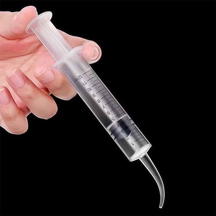 Hand holding a syringe with a needle on a black background