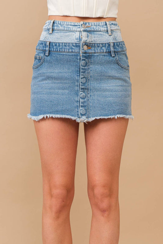 Woman wearing a two-tone denim skirt.