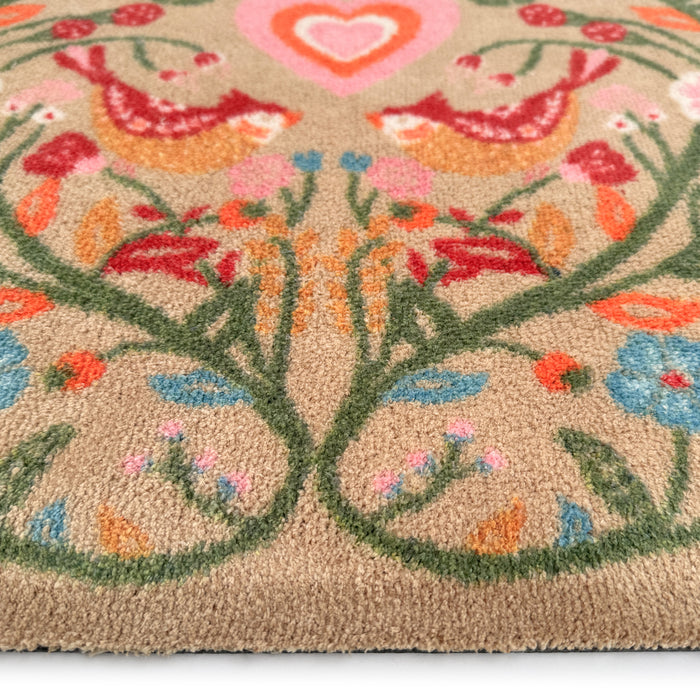 Garden Lovebirds Washable Runner- a 100% recycled cotton doormat featuring two lovebirds in shades of red, yellow, light pink, and cream, surrounded by floral vines.