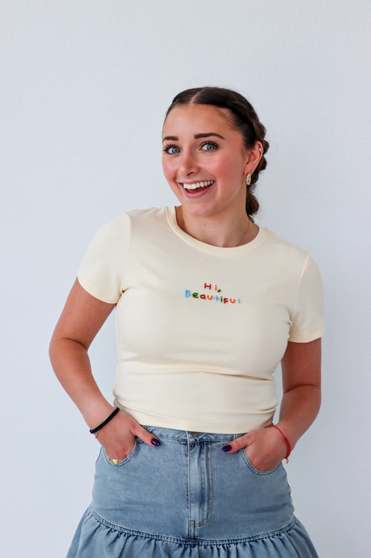 girl wearing cream "hi beautiful" graphic tee