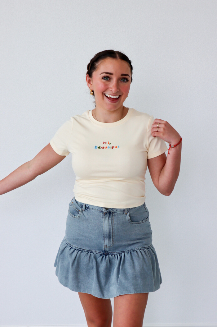 girl wearing cream "hi beautiful" graphic tee