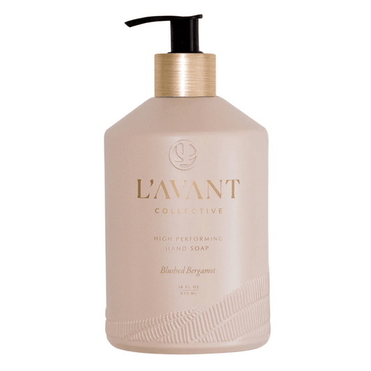 Bottle of High Performing Hand Soap - Blushed Bergamot | L'AVANT Collective in a matte light beige container with a gold pump dispenser, showcasing elegant skincare packaging.