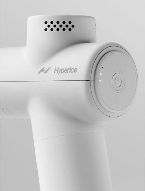 Close-up of the white Hypervolt Go 2 | Hyperice handheld recovery device showing the power button and ventilation holes on the sleek body designed for wellness and muscle care.