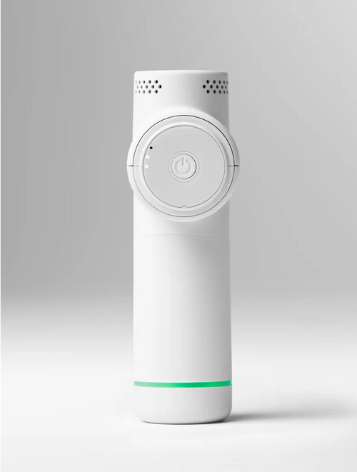 Minimalist white handheld wellness device with a circular power button and ventilation holes, resting on a white surface, Hypervolt Go 2 | Hyperice recovery tool.