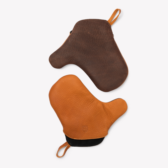 Pair of Field Leather Oven Mitts in tan and brown laid flat, overhead view