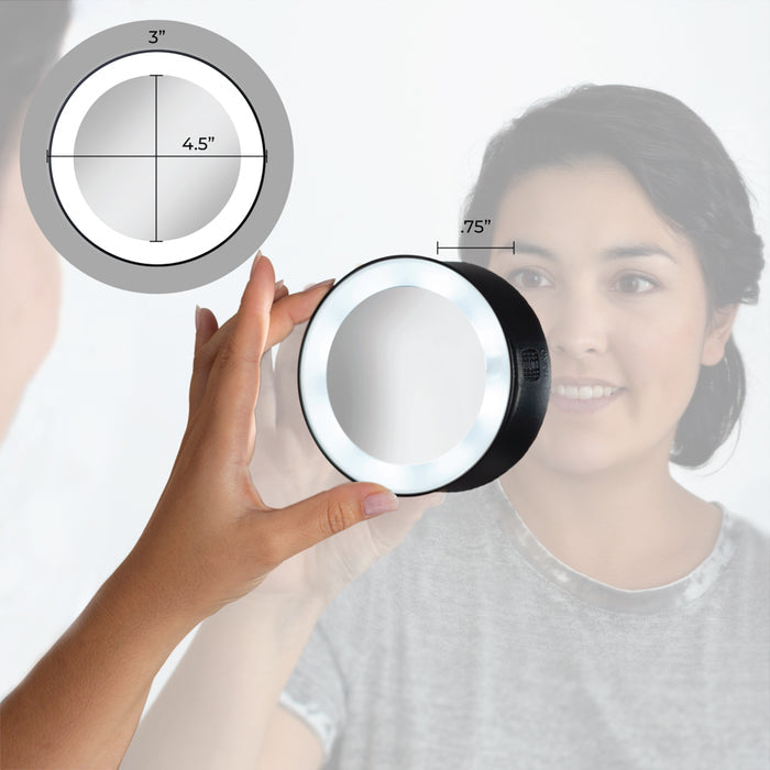 Zadro LED15X 705004419499 environment photo front view user mounting suction cup to vanity mirror with dimensions, lighted compact mirror with magnification & suction cups in front of a real life setting