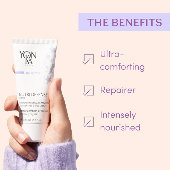 Hand holding a tube of Nutri Defense Creme | Yon-Ka Paris skincare product with text highlighting benefits: ultra-comforting, repairer, and intensely nourished for dry to very dry skin.