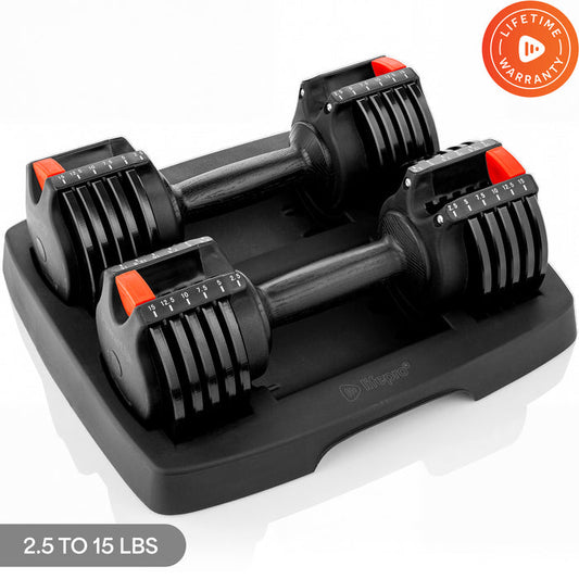 Pair of PowerUp Adjustable Dumbbells (2.5-15 lb) with red weight-selector dials, resting in their storage tray, and a Lifetime Warranty badge.