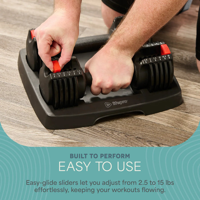 Hands adjusting the red weight-selector dial on the PowerUp Adjustable Dumbbells while resting in their storage tray.