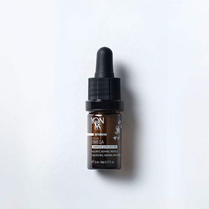 Small brown glass dropper bottle of Serum Omega | Yon-Ka Paris skincare product placed on a white background, highlighting luxury wellness and body care.