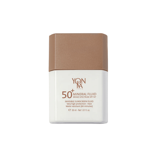 Bottle of SPF 50+ Mineral Fluid | YON-KA PARIS sunscreen with high protection, water-resistant formula designed for facial skincare.
