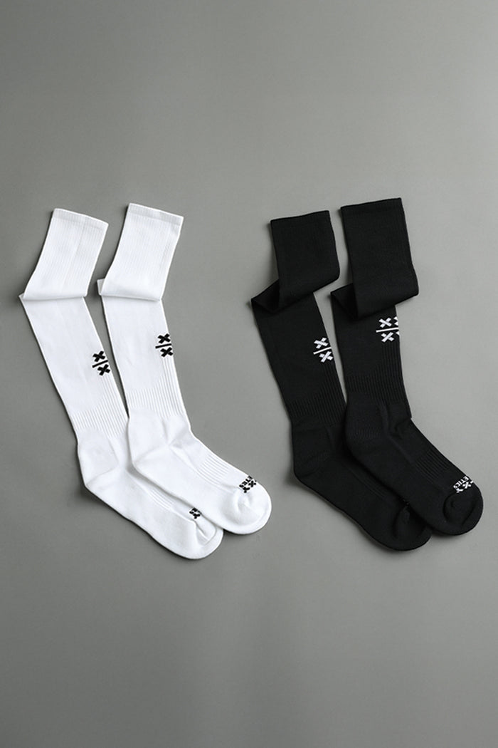 Two pairs of socks, one white and one black, on a gray background. || Black/White