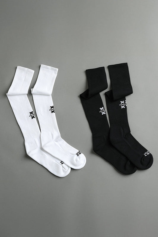 Two pairs of socks, one white and one black, on a gray background. || Black/White