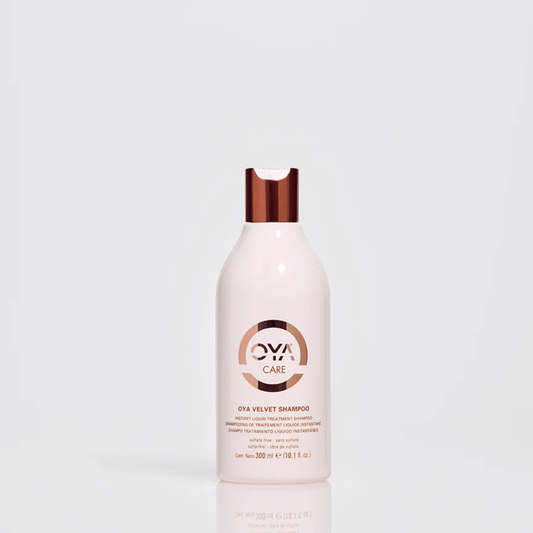Bottle of Velvet Shampoo | OYA with sleek white and copper design on a neutral background, emphasizing luxury hair care and wellness product aesthetics.