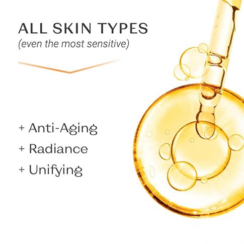 Close-up of golden serum droplets with a dropper, highlighting skincare benefits including anti-aging, radiance, and unifying properties for all skin types, featuring Serum C20 | Yon-Ka Paris.