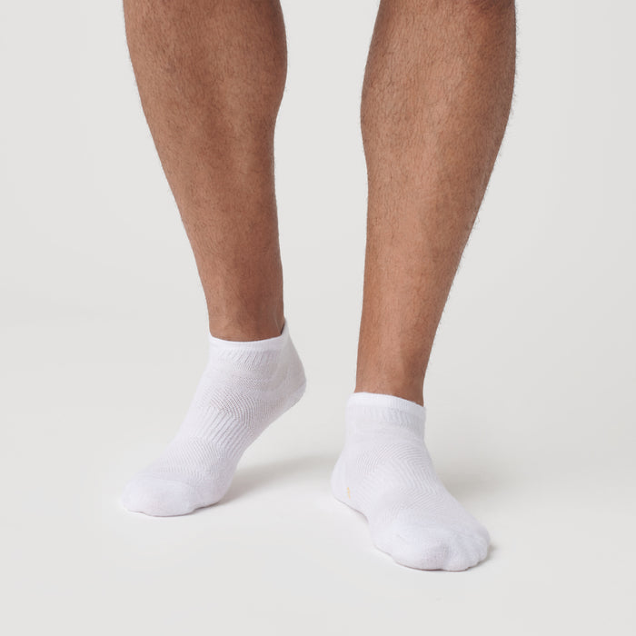White Ankle Socks 12-Pack worn on feet, showcasing seamless design.