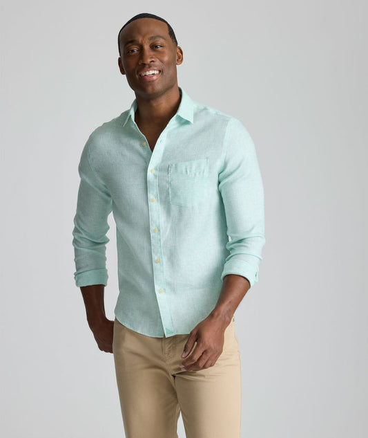 Model is wearing UNTUCKit Wrinkle-Resistant Linen Wildehart Shirt in green.